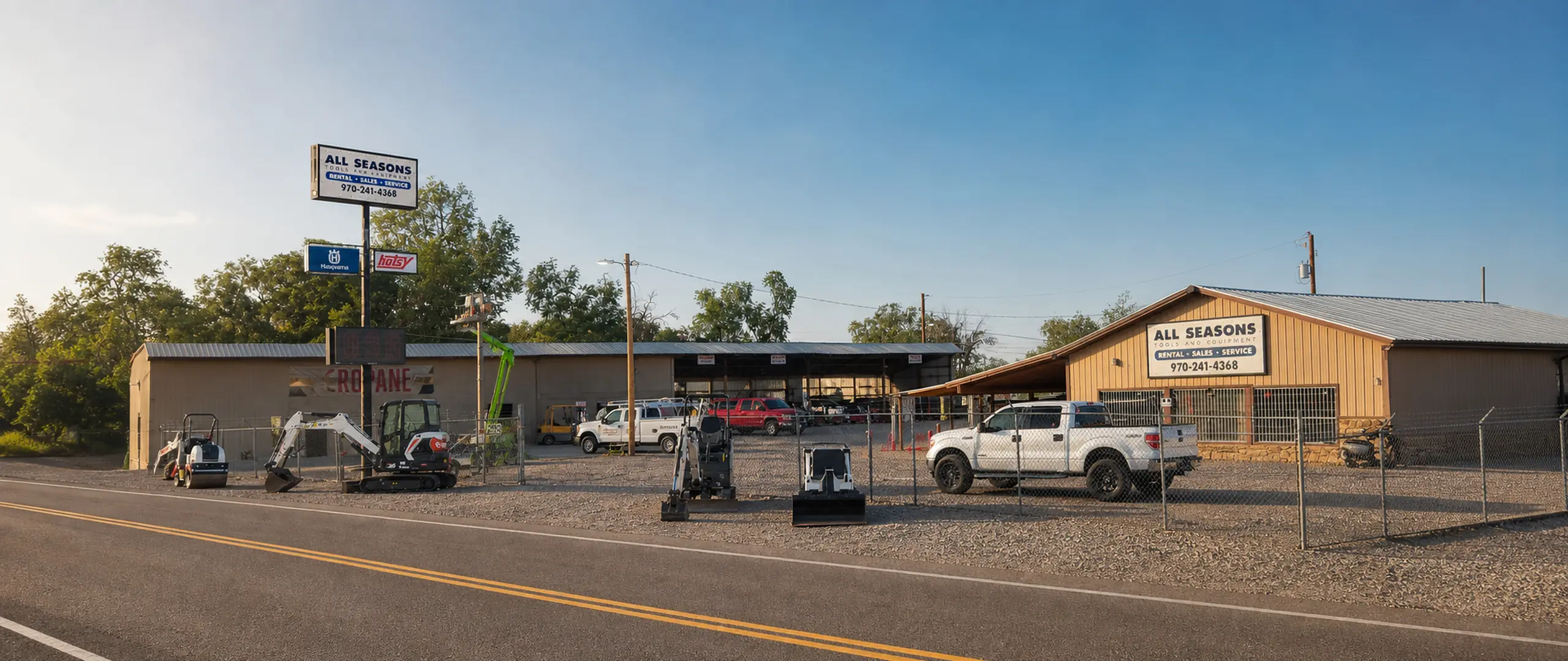 All Seasons Rentals yard on a clear Grand Junction morning, with excavators, a roller and service trucks ready to go